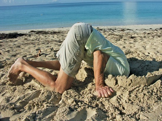 Man burying his head in sand